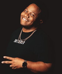 a man in a black shirt posing for a photo